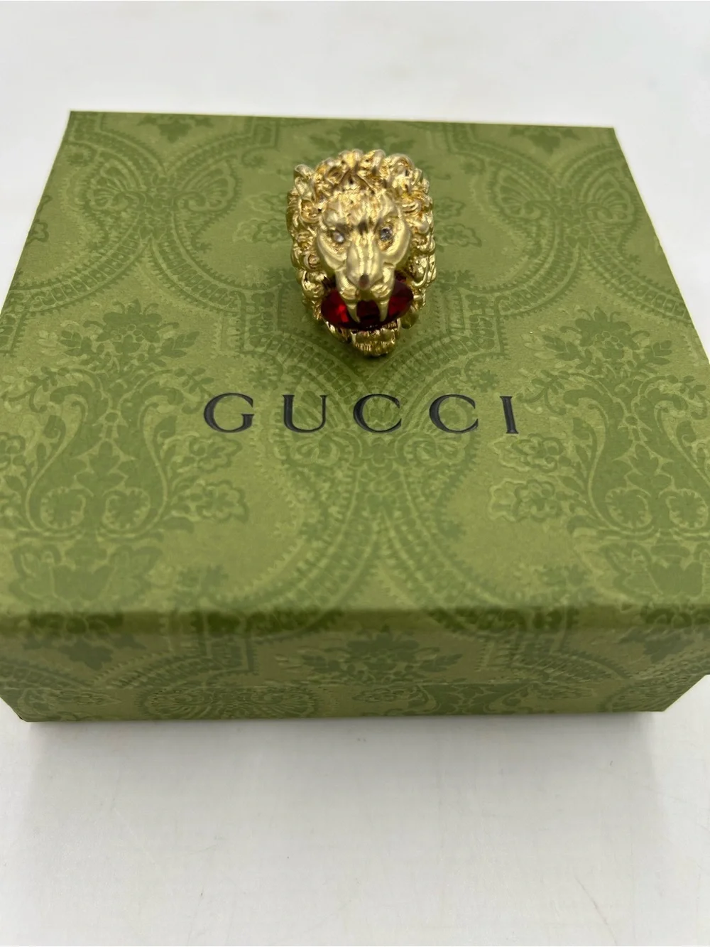 Unisex Gucci, Lionhead motif  gold tone with red crystal size 8.5 made in Italy